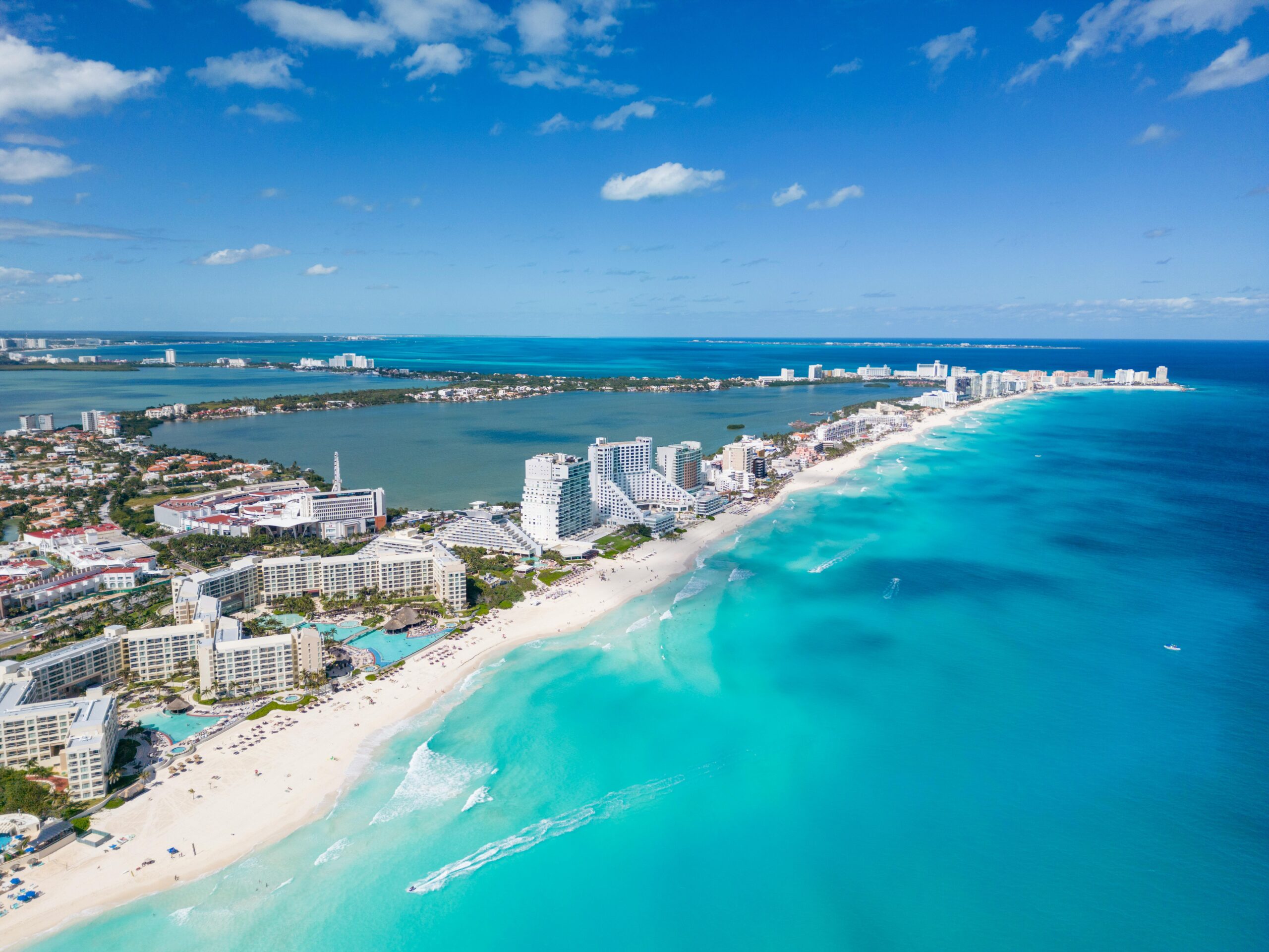 Beautiful aerial view of Cancun's coastline with clear blue waters and luxury resorts.